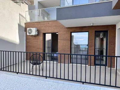 a balcony with a black fence and a chair at Casa Adora in Sozopol