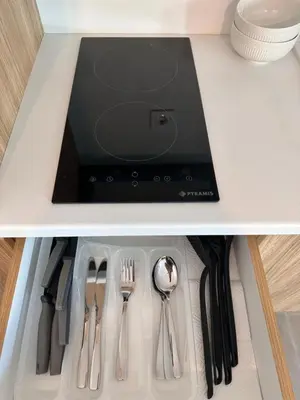 a table with utensils in a drawer with a tablet at Casa Adora in Sozopol