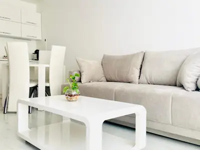 a living room with a couch and a white coffee table at Park suite in Burgas City