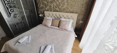 a bedroom with a bed with pillows on it at Patrick's apartments - Harmony Palace in Sunny Beach