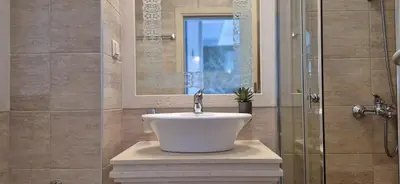 a bathroom with a sink and a shower at Patrick's apartments - Harmony Palace in Sunny Beach