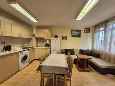 a kitchen and living room with a table and a couch at 2 Rooms Apartment - Top Center of Burgas in Burgas City