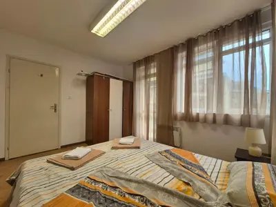 a bedroom with a bed with two towels on it at 2 Rooms Apartment - Top Center of Burgas in Burgas City