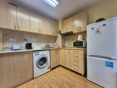a kitchen with a white refrigerator and a dishwasher at 2 Rooms Apartment - Top Center of Burgas in Burgas City