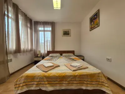 a bedroom with a bed with two towels on it at 2 Rooms Apartment - Top Center of Burgas in Burgas City