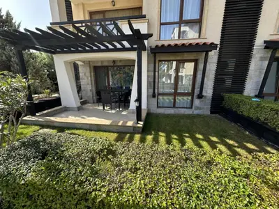 a pergola on a house with a yard at Oasis Beach Club - 