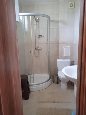 a bathroom with a shower and a toilet and a sink at Тристаен апартамент в Бяла комплекс Атлантик in Byala