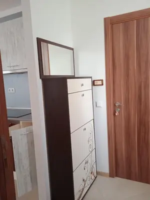 a kitchen with a refrigerator next to a door at Тристаен апартамент в Бяла комплекс Атлантик in Byala