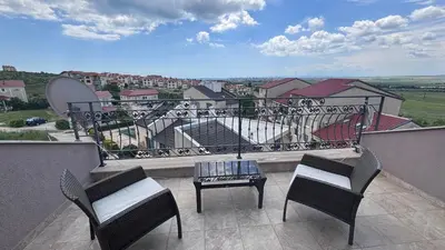 a balcony with two chairs and a table with a view at Relax in Kosharica in Kosharitsa