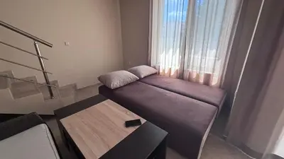 a small couch in a room with a window at Relax in Kosharica in Kosharitsa