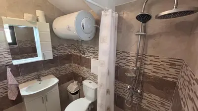 a bathroom with a shower with a toilet and a sink at Relax in Kosharica in Kosharitsa