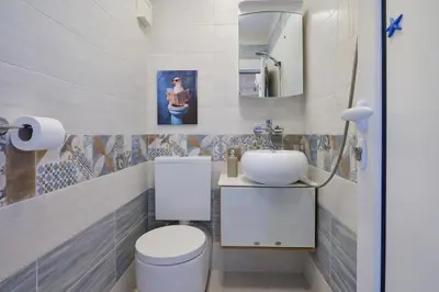 a bathroom with a toilet and a sink at Sirena Seaview Apartment - FREE PARKING in Varna City