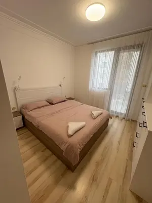 a bedroom with a bed and a large window at Ravda Apolon 9 Apartment in Ravda