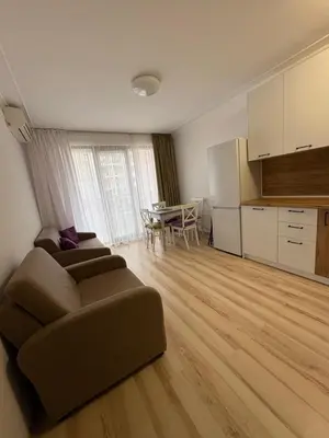 a living room with a couch and a table at Ravda Apolon 9 Apartment in Ravda