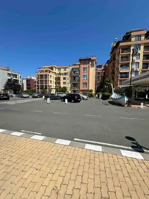 an empty parking lot in a city with buildings at Свети Влас комплекс Викторио in Burgas City