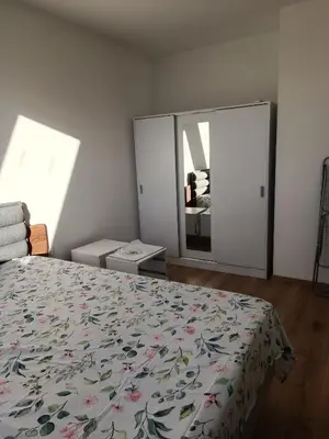 a bedroom with a bed and a large mirror at 2 Zimmerwohnung in Shkorpilovtsi