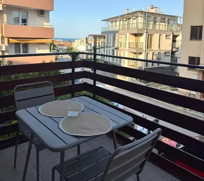 a blue table and two chairs on a balcony at Apartment 7 in Sozopol