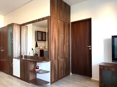 a room with a large wooden cabinet with a mirror at Apartment 7 in Sozopol