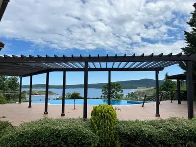 a pavilion with a view of a swimming pool at Saint Thomas Holiday Village Condo in Sozopol