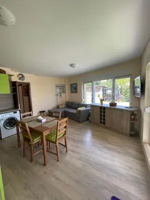 a living room with a table and a couch at Sarafovo Summer 1 - Relaxing Apartment Near Beach in Sarafovo