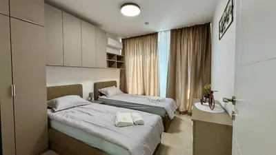 a hotel room with two beds and a window at Emperium 1 Apartments Sveti Vlas in Sveti Vlas
