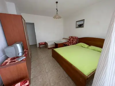 a small bedroom with a bed and a tv at Anastra in Pomorie