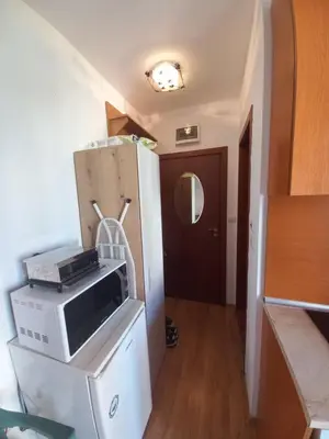 a microwave sitting on top of a refrigerator in a room at Cozy studio 150m from the beach in Sveti Vlas