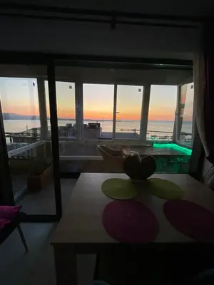 a room with a table and a view of a pool at Sea view apartment in Sozopol