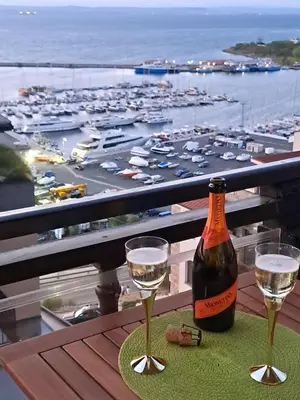 a bottle of wine and two glasses on a table at Sea view apartment in Sozopol
