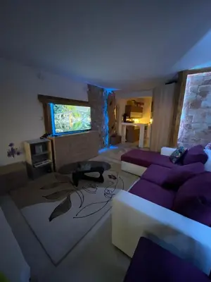 a living room with a couch and a tv at Sea view apartment in Sozopol