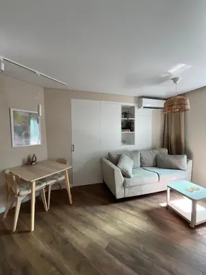 a living room with a couch and a table at Lazur Beach Residence - 10min walk to beach in Burgas City