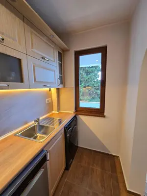 a small kitchen with a sink and a window at Super Lovely Apartment in Burgas City