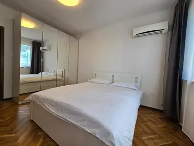 a bedroom with a white bed and a mirror at Super Lovely Apartment in Burgas City