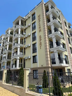 a large apartment building with a fence in front of it at VP Morski Briag in Sveti Vlas
