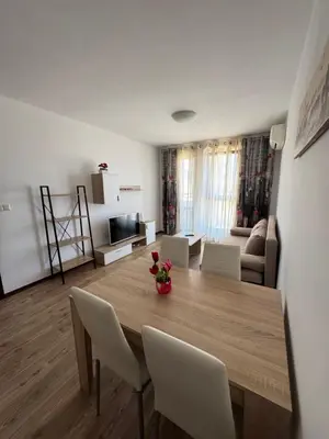 a living room with a wooden table and chairs at VP Morski Briag in Sveti Vlas