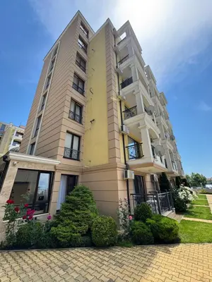 a tall building with bushes in front of it at VP Morski Briag in Sveti Vlas