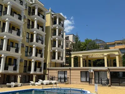 a building with a swimming pool in front of it at VP Morski Briag in Sveti Vlas