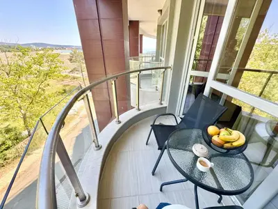a balcony with a table and a bowl of fruit on it at Sea View Allure Studio with Balcony in Primorsko