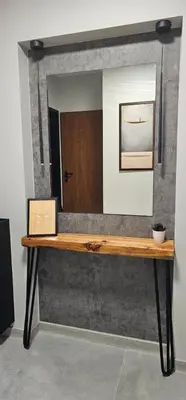 a mirror sitting on top of a wooden table at Ika Delux in Burgas City