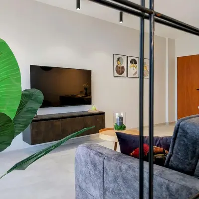 a living room with a couch and a bed at Ika Delux in Burgas City