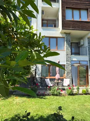 a woman standing in a yard in front of a house at Sea Garden Escape - Byala in Byala