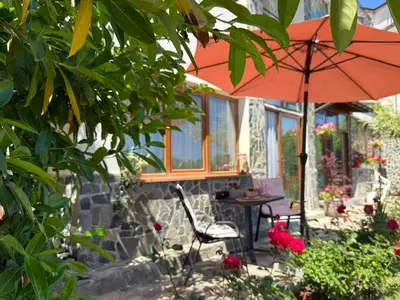 a patio with an umbrella and a table and chair at Sea Garden Escape - Byala in Byala