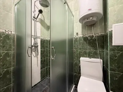 a bathroom with a shower and a white toilet at Sea Garden Escape - Byala in Byala