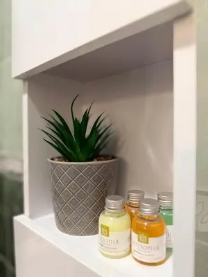 a shelf with three jars of honey and a potted plant at Sea Garden Escape - Byala in Byala