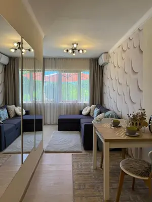 a living room with a blue couch and a table at Sea Garden Escape - Byala in Byala