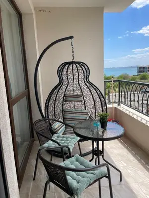 a balcony with a table and chairs on a balcony at Сарафово Family in Burgas City