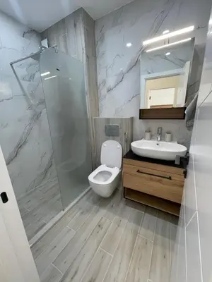 a bathroom with a toilet and a sink and a shower at Сарафово Family in Burgas City