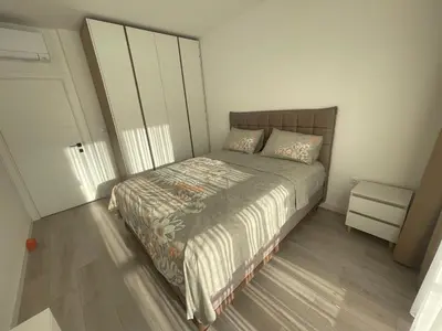 a small bedroom with a bed and a closet at Сарафово Family in Burgas City