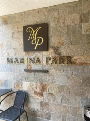a sign for a marinana park on a brick wall at Marina Park OLIWIA in Sveti Vlas