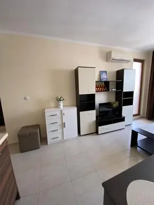 a living room with white cabinets and a refrigerator at Marina Park OLIWIA in Sveti Vlas